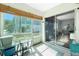 Light-filled sunroom with tile floors, glass table, and sliding glass doors leading to living area at 22375 Edgewater Dr # 123, Punta Gorda, FL 33980