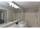 Bright bathroom with granite countertop, updated fixtures, and shower and tub combination at 2250 Homestead Cir, North Port, FL 34286