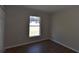 Well-lit bedroom with wood flooring and a view to the outside at 2250 Homestead Cir, North Port, FL 34286