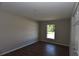 Bright bedroom featuring wood flooring, neutral paint, and a sunny window at 2250 Homestead Cir, North Port, FL 34286