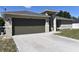 Close-up of a single-story home showing a two car garage and neutral colored paint at 2250 Homestead Cir, North Port, FL 34286