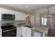 Modern kitchen with stainless steel appliances, stylish granite countertops, and white cabinetry at 2250 Homestead Cir, North Port, FL 34286