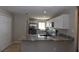 Bright kitchen featuring stainless steel appliances, granite countertops, and white cabinets at 2250 Homestead Cir, North Port, FL 34286