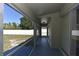 View of the backyard from the home's screened-in lanai. The lanai also has sliding door access to the home at 2250 Homestead Cir, North Port, FL 34286