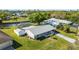 Aerial view of a lovely home featuring a screened pool, lush landscaping, and canal access at 2331 Cannolot Blvd, Port Charlotte, FL 33948