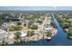 Aerial view of waterfront property featuring a pool, boat dock, and lush surroundings at 2331 Cannolot Blvd, Port Charlotte, FL 33948