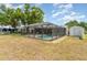 Spacious backyard with a screened-in pool area, offering a private oasis for relaxation and recreation at 2331 Cannolot Blvd, Port Charlotte, FL 33948