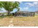 Expansive backyard featuring a screened-in pool area with ample space for outdoor activities at 2331 Cannolot Blvd, Port Charlotte, FL 33948