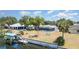 Spacious waterfront backyard with a screened pool, boat dock, and lush landscaping at 2331 Cannolot Blvd, Port Charlotte, FL 33948