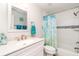 Bright bathroom featuring decorative shower curtain and white vanity at 2331 Cannolot Blvd, Port Charlotte, FL 33948