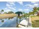 Picturesque waterfront view with a private boat dock and lift, perfect for boating enthusiasts at 2331 Cannolot Blvd, Port Charlotte, FL 33948