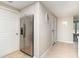 Spacious hallway features stainless steel refrigerator and tile flooring at 2331 Cannolot Blvd, Port Charlotte, FL 33948