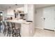 Modern kitchen with breakfast bar, white cabinets, and stainless-steel appliances, adjacent to entry at 2331 Cannolot Blvd, Port Charlotte, FL 33948
