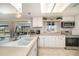 Bright kitchen with white cabinetry, stainless steel appliances, and a view of the pool at 2331 Cannolot Blvd, Port Charlotte, FL 33948