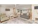 Open-concept living room with tile floors, comfortable seating, and seamless flow to the dining area at 2331 Cannolot Blvd, Port Charlotte, FL 33948