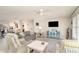 Cozy living room with stylish furnishings, neutral color palette, and access to the kitchen at 2331 Cannolot Blvd, Port Charlotte, FL 33948
