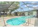 Inviting screened-in pool area with lounge chairs, providing a perfect spot for relaxation and leisure at 2331 Cannolot Blvd, Port Charlotte, FL 33948