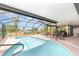 Screened-in pool area with lounge chairs, grill, and covered patio for outdoor relaxation at 2331 Cannolot Blvd, Port Charlotte, FL 33948