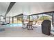 Enclosed, private pool area with a table and chairs offering an ideal outdoor living and entertainment space at 2331 Cannolot Blvd, Port Charlotte, FL 33948