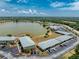Aerial view showcasing lakeside apartments with well-maintained grounds, landscaping, and convenient parking at 25225 Rampart Blvd # 1603, Punta Gorda, FL 33983