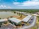 Aerial view of the condo building with a beautiful lake and plenty of parking at 25225 Rampart Blvd # 1603, Punta Gorda, FL 33983