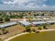 Aerial view of lakeside apartments featuring well-maintained grounds, lake access, and landscaping at 25225 Rampart Blvd # 1603, Punta Gorda, FL 33983