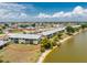 Aerial view of condo building with waterfront access and a beautiful lawn at 25225 Rampart Blvd # 1603, Punta Gorda, FL 33983