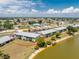 Aerial view of lakeside apartments showcasing well-maintained grounds and lake access at 25225 Rampart Blvd # 1603, Punta Gorda, FL 33983