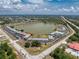 Aerial shot showcasing property surrounded by a lake, with ample parking and green spaces at 25225 Rampart Blvd # 1603, Punta Gorda, FL 33983