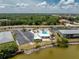 Aerial view highlighting the community pool, lush landscaping, and ample parking at the lakeside apartments at 25225 Rampart Blvd # 1603, Punta Gorda, FL 33983