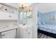 Bathroom featuring a vanity and toilet, leading to a bedroom with matching nautical themed bedding at 25225 Rampart Blvd # 1603, Punta Gorda, FL 33983