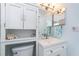 Well-lit bathroom with a decorative mirror, modern vanity, and stylish accessories at 25225 Rampart Blvd # 1603, Punta Gorda, FL 33983