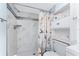 Bathroom featuring a walk-in shower with decorative accent tile, and built-in shelving above the toilet at 25225 Rampart Blvd # 1603, Punta Gorda, FL 33983