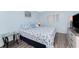 Inviting bedroom with a coastal-themed quilt, glass side table, and sleek gray flooring at 25225 Rampart Blvd # 1603, Punta Gorda, FL 33983