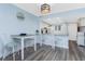 Cozy dining area adjacent to the kitchen features new light fixture and coastal accents at 25225 Rampart Blvd # 1603, Punta Gorda, FL 33983