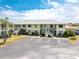 Exterior view of a two story home with balconies and a parking lot at 25225 Rampart Blvd # 1603, Punta Gorda, FL 33983