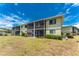Exterior of building showcasing screened patios, multiple units and well-maintained lawns at 25225 Rampart Blvd # 1603, Punta Gorda, FL 33983