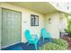 Inviting front porch with two aqua chairs, perfect for relaxing outdoors at 25225 Rampart Blvd # 1603, Punta Gorda, FL 33983