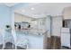 Bright kitchen featuring white cabinets, granite countertops, a breakfast bar, updated appliances, and a skylight at 25225 Rampart Blvd # 1603, Punta Gorda, FL 33983