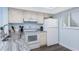 Bright kitchen featuring white cabinets, granite countertops, updated appliances, and a window at 25225 Rampart Blvd # 1603, Punta Gorda, FL 33983