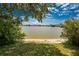 Scenic lake view framed by lush greenery, providing a tranquil and natural setting at 25225 Rampart Blvd # 1603, Punta Gorda, FL 33983