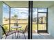 Relaxing screened lanai with patio furniture and view of the lush green lawn at 25225 Rampart Blvd # 1603, Punta Gorda, FL 33983