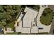 An aerial view of a modern house, pool, manicured lawns, a driveway, and surrounding trees at 2523 Ryan Blvd, Punta Gorda, FL 33950