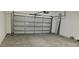 View of the garage showing an insulated garage door and concrete flooring at 2585 Yuma Ave, North Port, FL 34286