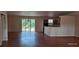 Open-concept living area with a view of the kitchen and access to the backyard at 2585 Yuma Ave, North Port, FL 34286