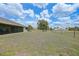 Wide open backyard featuring a screened-in lanai with plenty of green space at 26103 Salonika Ln, Punta Gorda, FL 33983