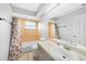 Traditional bathroom with tile shower, vanity, and a large mirror creating ample lighting at 26103 Salonika Ln, Punta Gorda, FL 33983