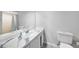 Bathroom with a clean vanity, toilet, and a large mirror, offering ample lighting at 26103 Salonika Ln, Punta Gorda, FL 33983