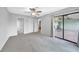 A spacious carpeted bedroom with a ceiling fan and sliding glass doors leading to an outdoor patio at 26103 Salonika Ln, Punta Gorda, FL 33983
