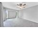 Light and airy bedroom with neutral tones, carpet, and windows that provide natural light at 26103 Salonika Ln, Punta Gorda, FL 33983